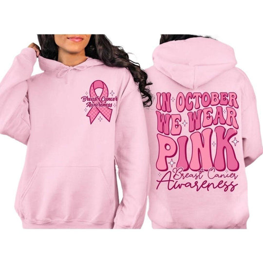 Light pink hoodie with breast cancer awareness ribbon and October message in bold pink font, perfect for streetwear support fashion.