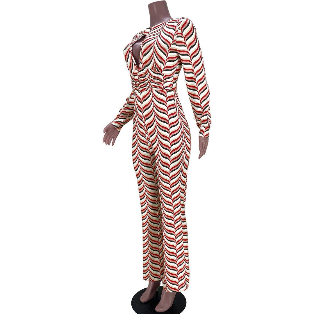 Side view of Smocked Print Flared Jumpsuit on mannequin, emphasizing the fitted waist and flared leg design with bold red and white print.