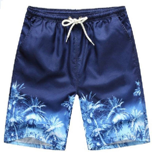 Blue men's beach shorts with tropical palm tree print, perfect for a relaxed and stylish beach day.