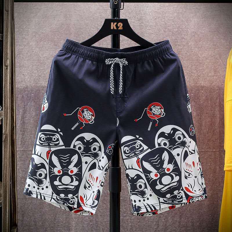 Men's beach shorts with traditional Japanese mask and Daruma doll prints, offering a unique and cultural summer style.