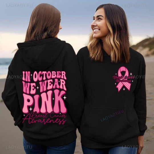 Matching black hoodies with pink breast cancer awareness graphics, ideal for October support events and awareness campaigns.