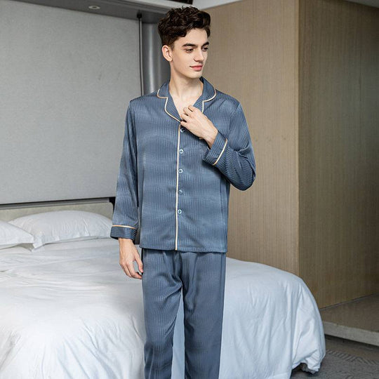 Men's long-sleeved blue ice silk pajamas set with a chest pocket and elegant trim, combining comfort and modern loungewear style.