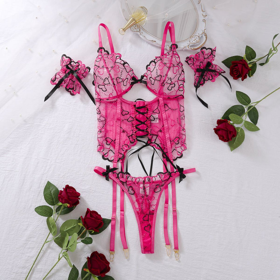 Women's Lace-up Set - Embroidered Underwear displayed with roses and mirror, highlighting romantic design and heart embroidery in pink.
