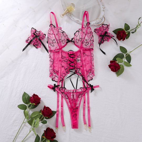 Women's Lace-up Set - Embroidered Underwear displayed with roses and mirror, highlighting romantic design and heart embroidery in pink.
