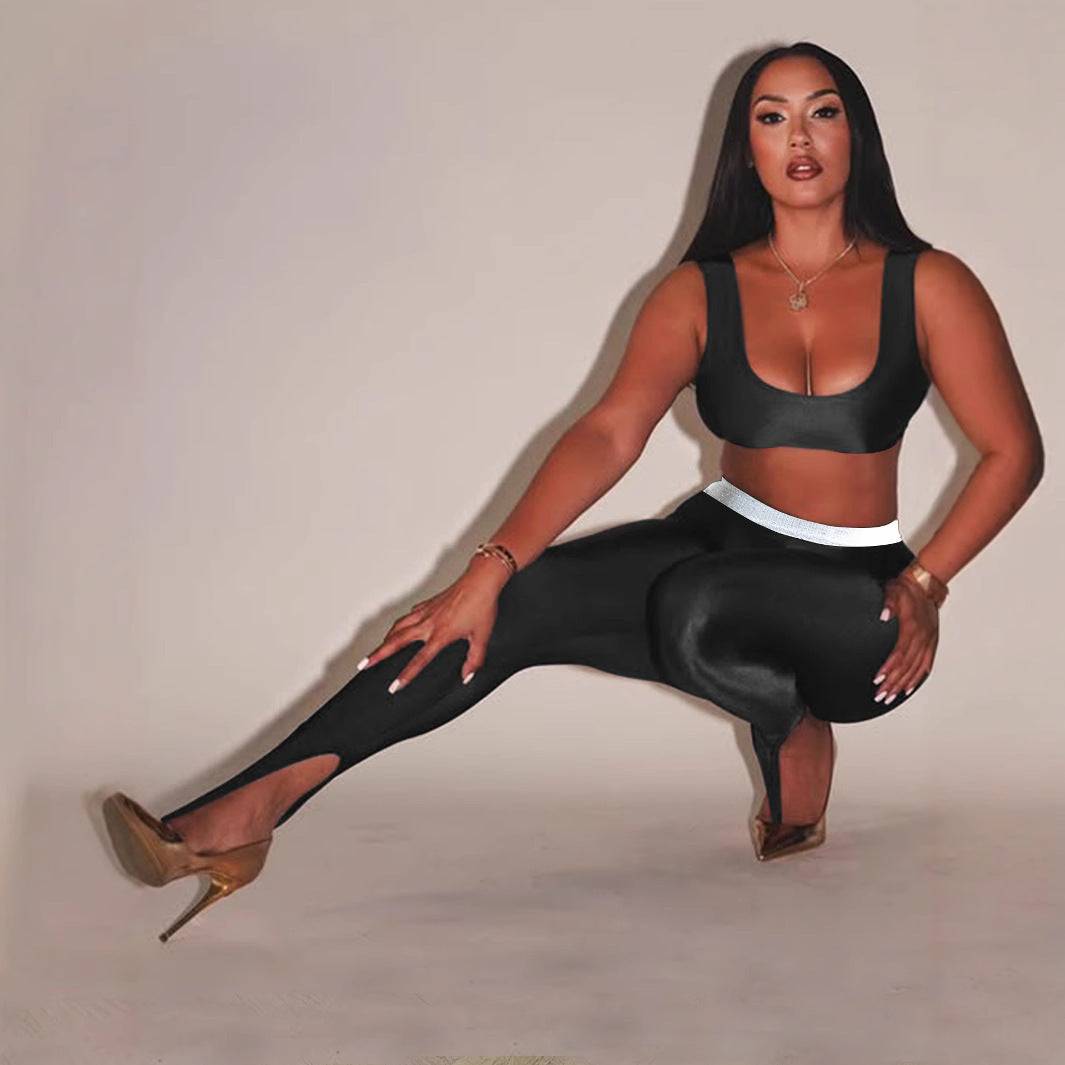 Front Step Shiny Leggings - Slim Fit Nylon Trousers in black, featuring high stretch and stirrup detail, styled with crop top and heels.