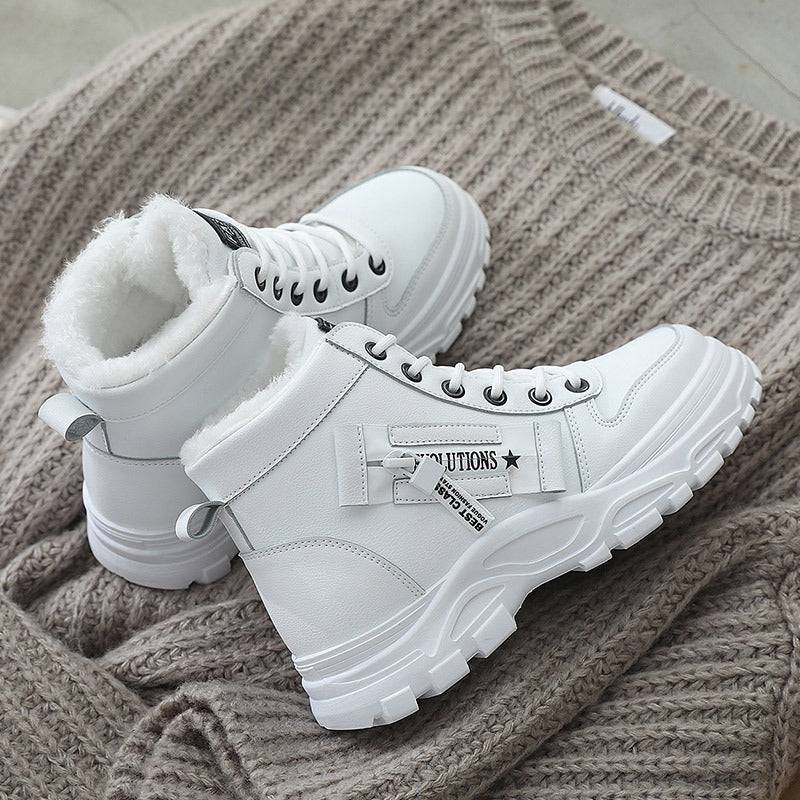 White Korean High-top Martin Boots placed on a knit sweater, featuring warm lining and durable flat heel design.