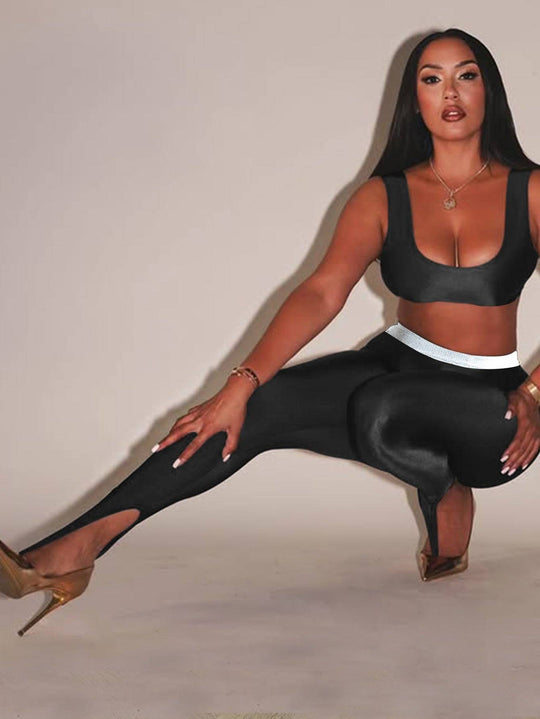 Front Step Shiny Leggings - Slim Fit Nylon Trousers in black, featuring high elasticity and stirrup hem, styled with crop top and heels.