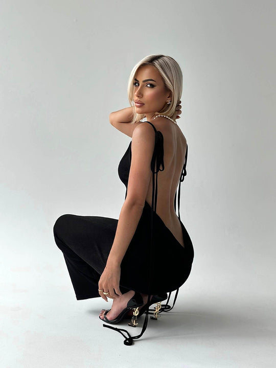 Black Slim Backless Lace-up Dress with a sleek silhouette and dramatic open back, styled with gold heels for a chic summer look.