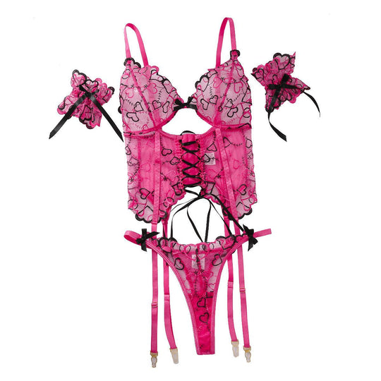 Flat lay of Women's Embroidered Lace-up Underwear Set with lace-up corset, thong, and wrist cuffs in pink and black embroidery.