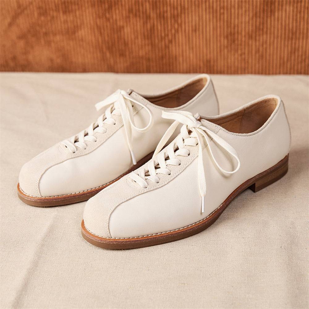 Men's vintage cowhide shoes in off-white leather with platform sole, showcasing stylish and durable craftsmanship on neutral fabric background.