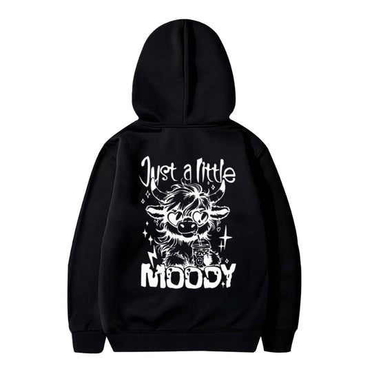 Black polyester hoodie with white 'Just a Little Moody' cow design, part of American casual trend fashion collection.