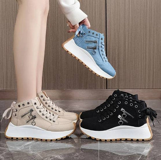 Women's platform fashion sneakers in black, khaki, and blue with high-top design, chunky sole, and zipper heart charm detail.