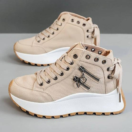 Khaki women's platform sneakers with high-top silhouette, lace-up front, and decorative zipper charms, ideal for casual outfits.