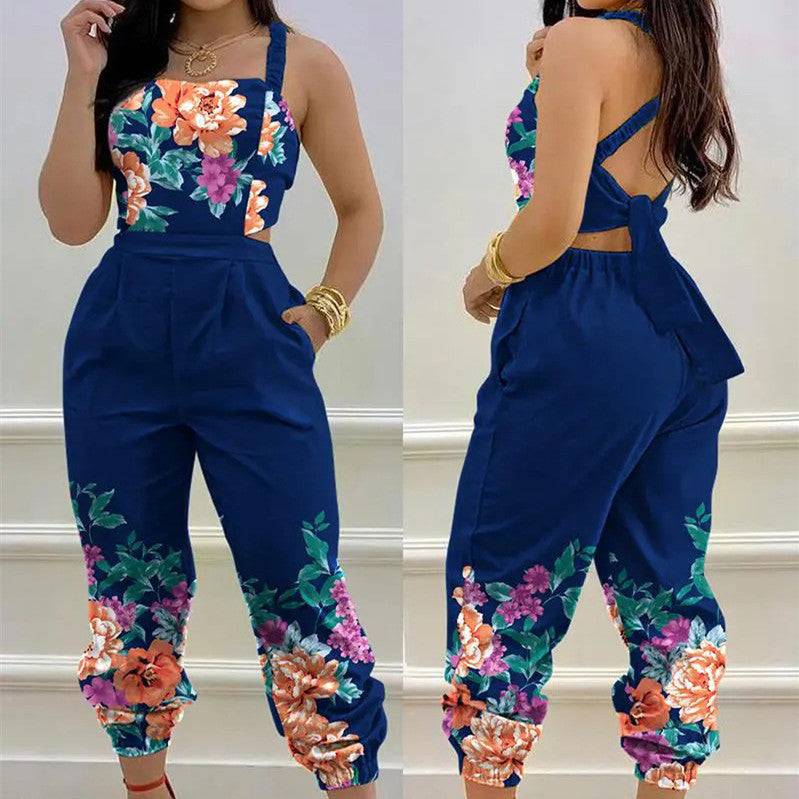 Women's casual print jumpsuit in navy with vibrant floral patterns and waist tie-back. Ideal for stylish everyday wear and summer outings.